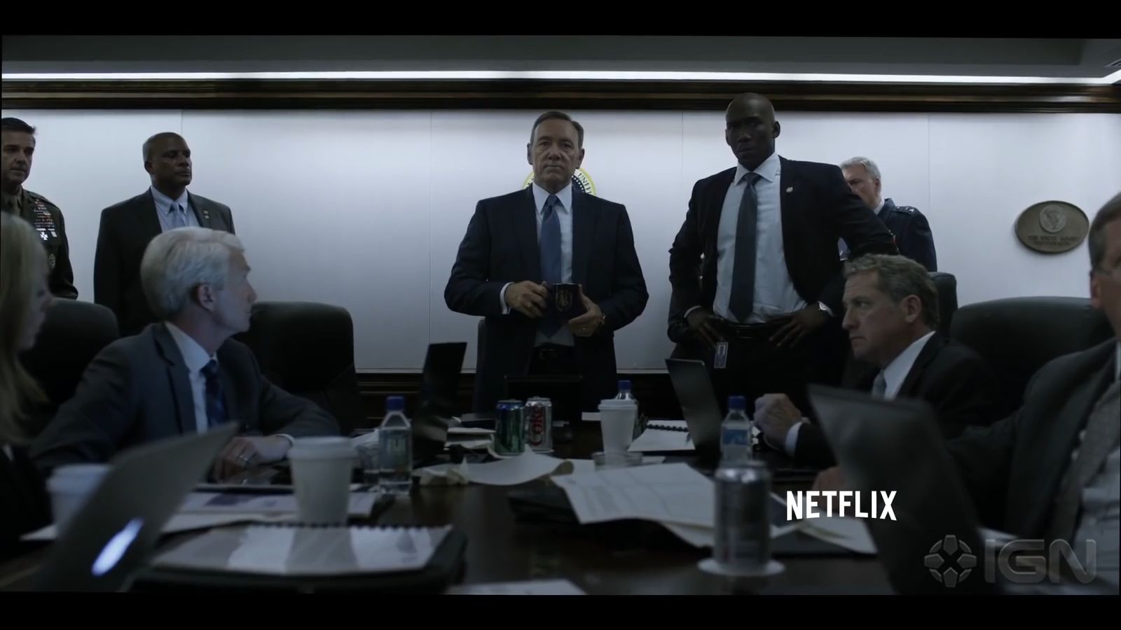 a group of men in suits and ties sitting around a table