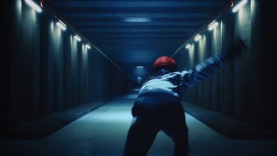 a person in a hallway with a red hat on