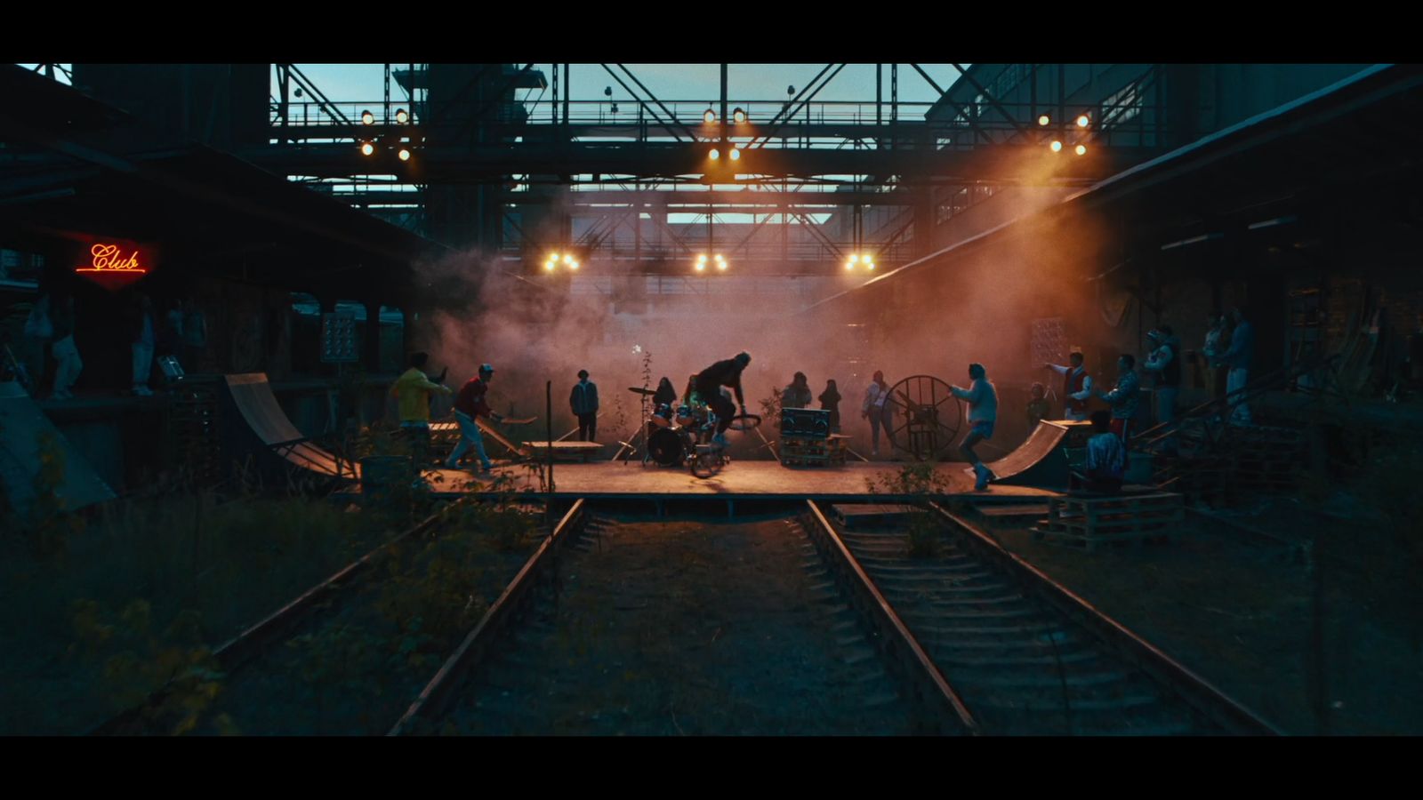 a group of people standing on top of a train track