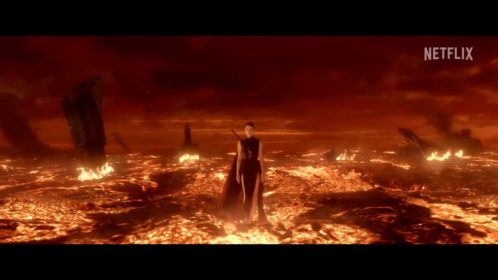 a man standing in the middle of a fire filled ocean