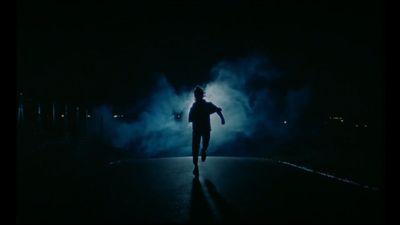 a person standing in the middle of a dark street