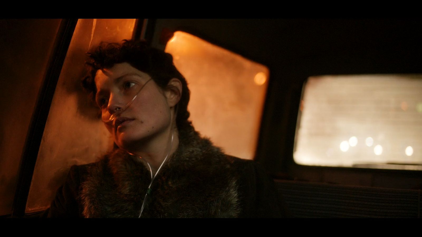 a woman sitting in the back seat of a car