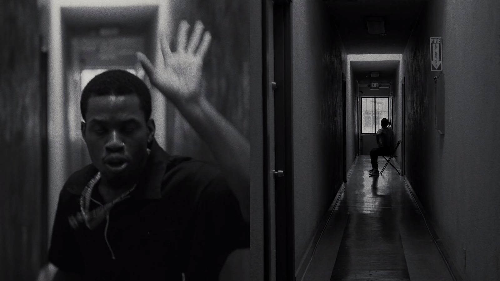 a man standing in a hallway with his hand up