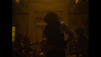 a person playing a guitar in a dark room