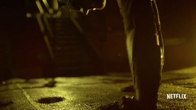 a person walking down a street at night