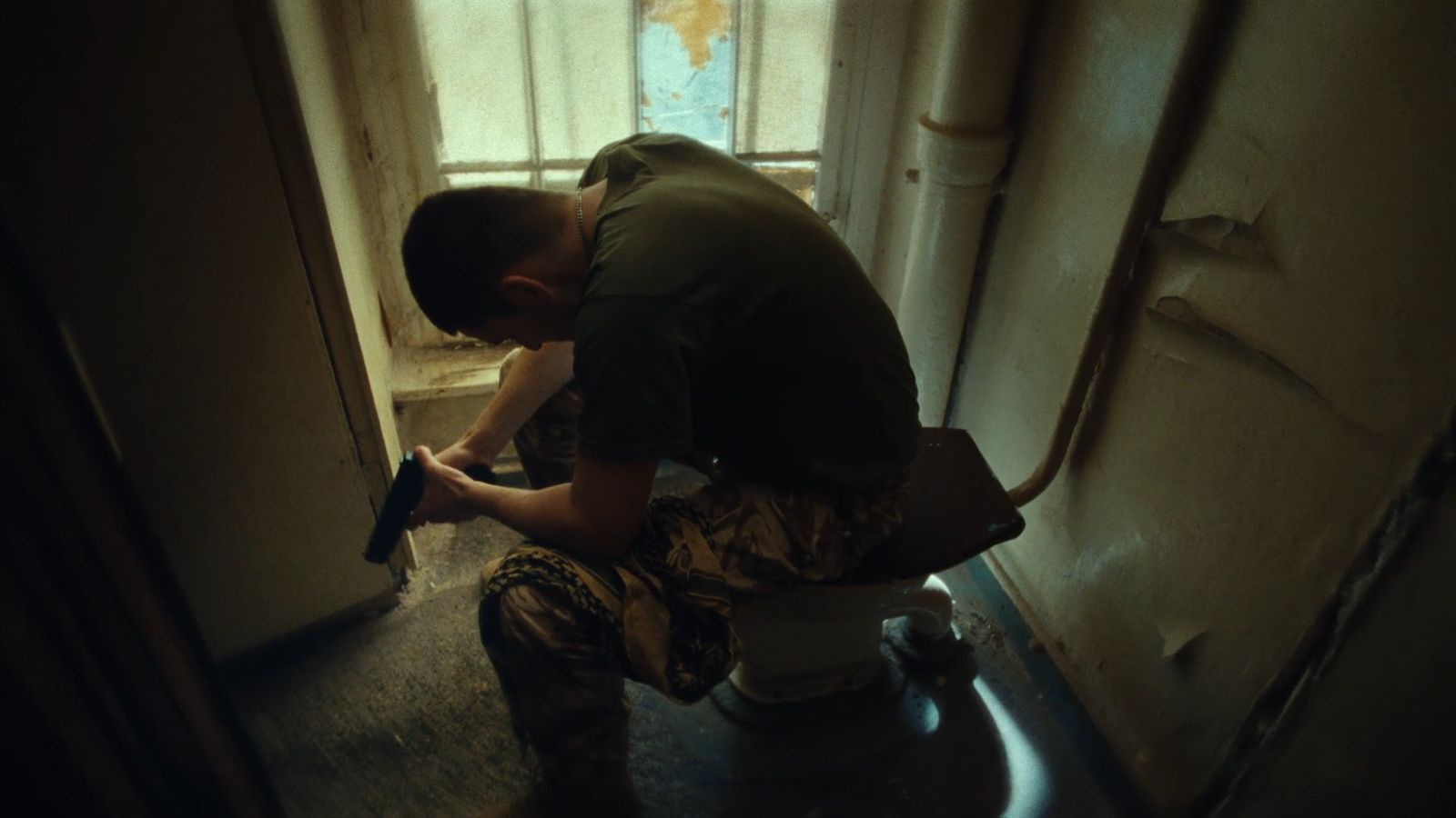 a man sitting on a toilet in a bathroom