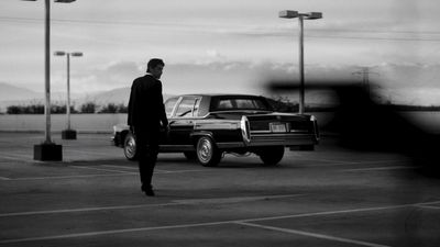 a man standing in a parking lot next to a truck