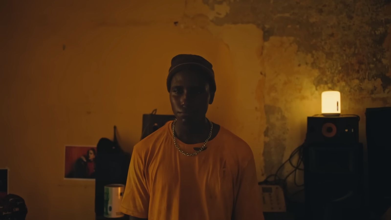 a man in a yellow shirt standing in a room