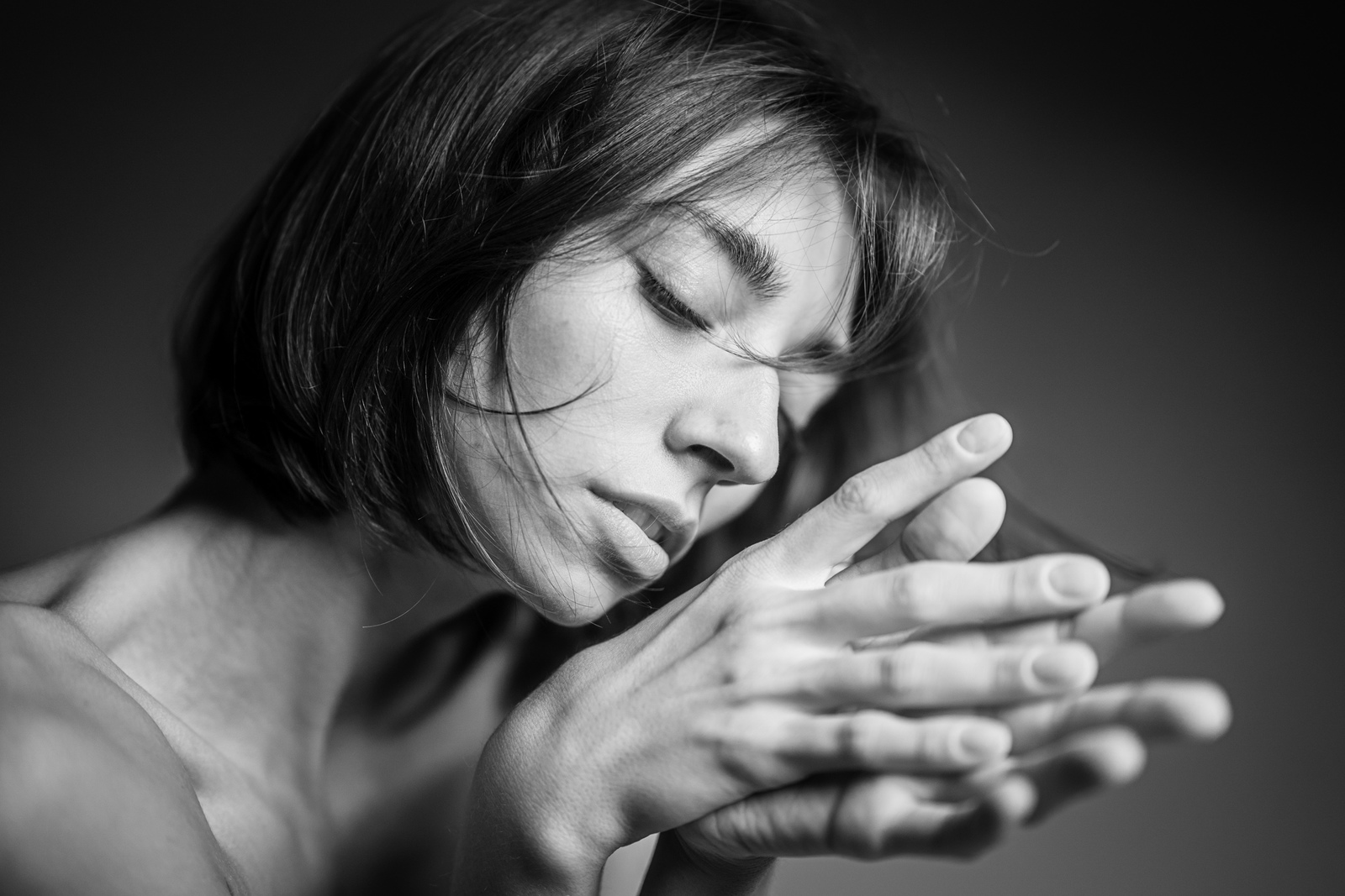 a black and white photo of a woman holding her hands together