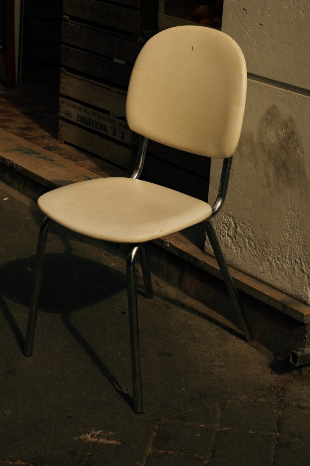 a white chair sitting in front of a building