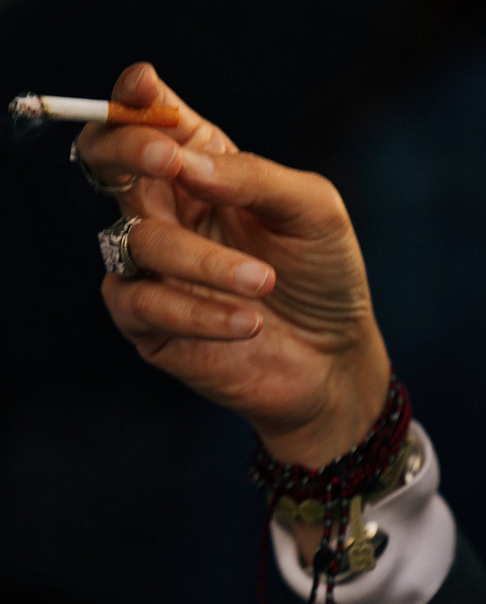 a person holding a cigarette in their hand