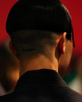 the back of a man's head with a mohawk undercut