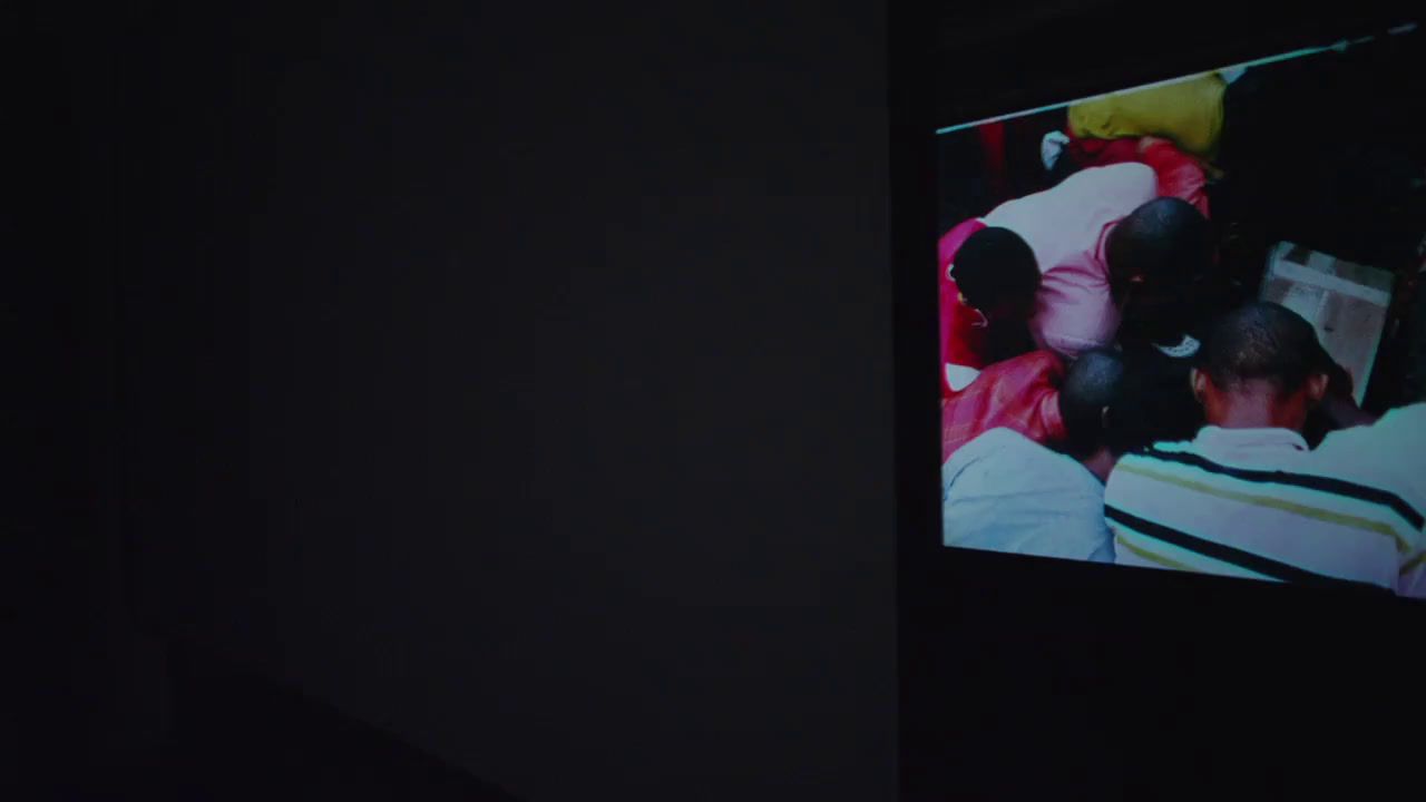 a group of people sitting in a dark room