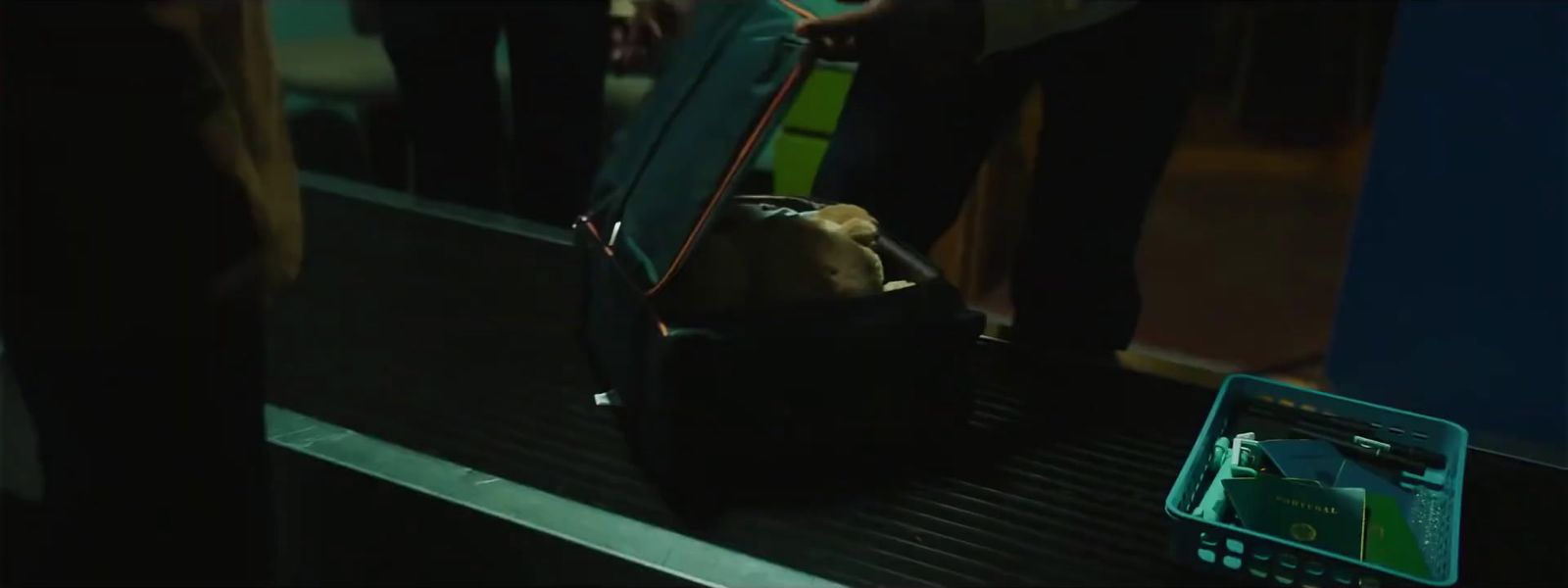 a group of people standing on a train next to a luggage bag