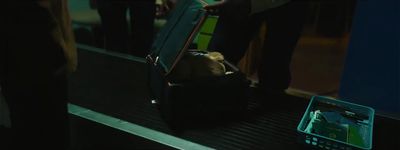 a group of people standing on a train next to a luggage bag