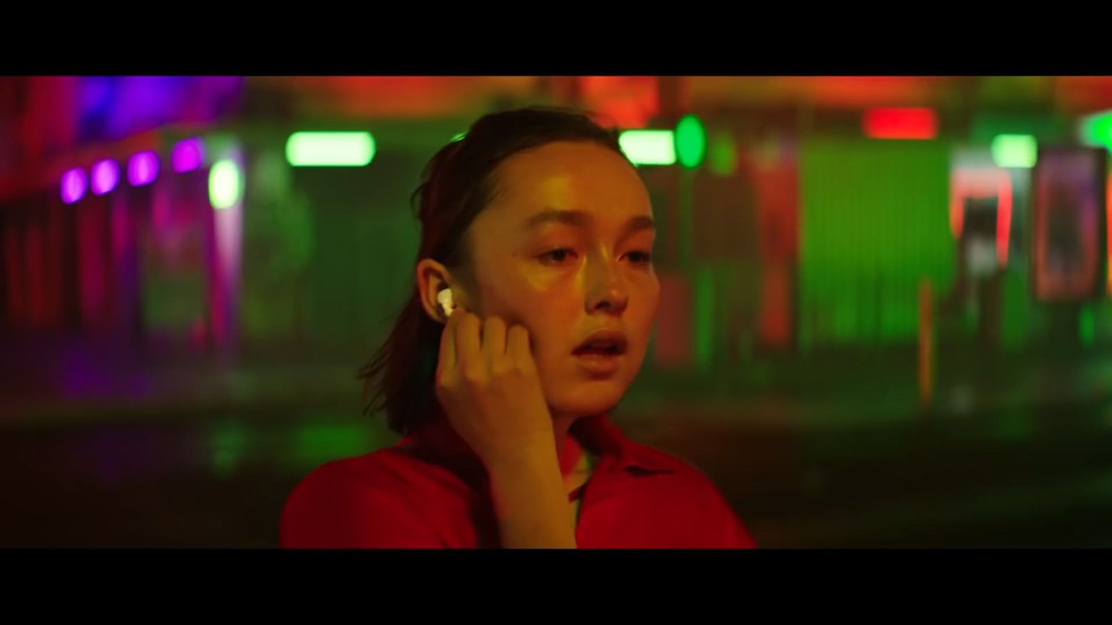 a woman in a red shirt talking on a cell phone