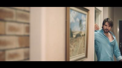 a man standing in front of a picture of a palm tree