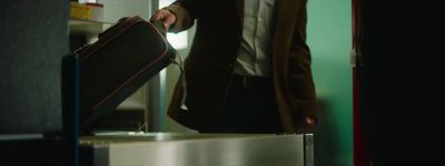 a man holding a suit case in his hand