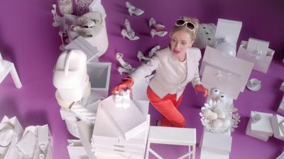 a young girl is surrounded by white objects