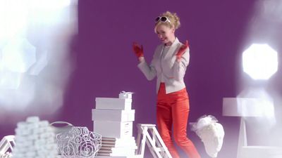 a woman standing on top of a pile of boxes