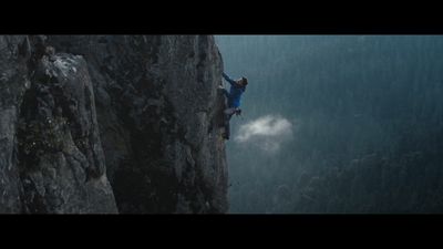 a man climbing up the side of a cliff