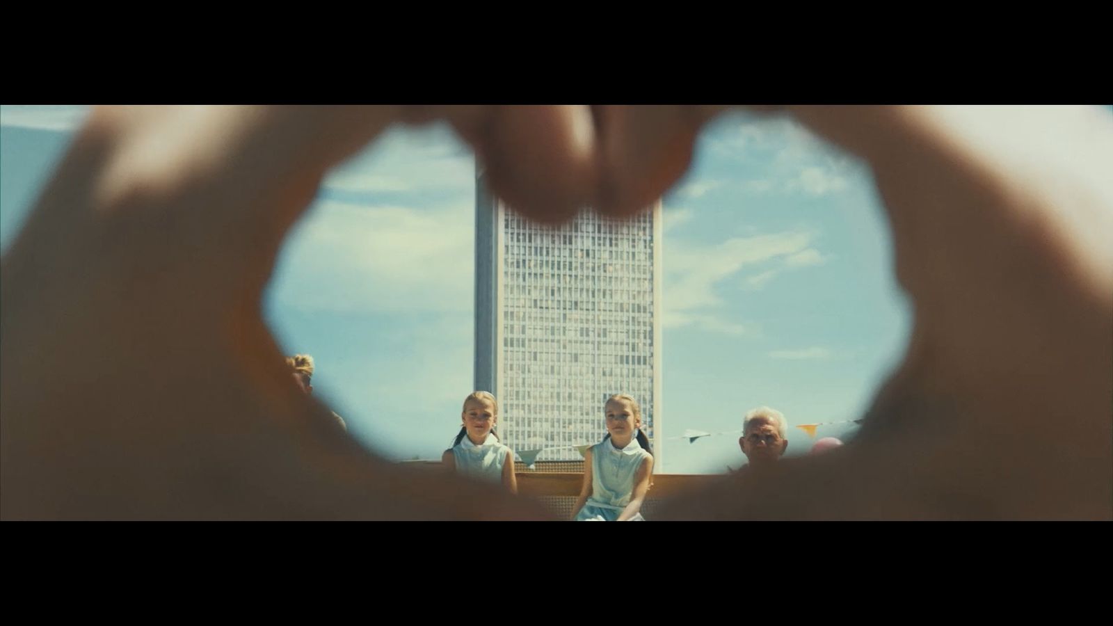 a group of people standing in front of a tall building