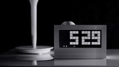 a digital clock sitting on top of a table