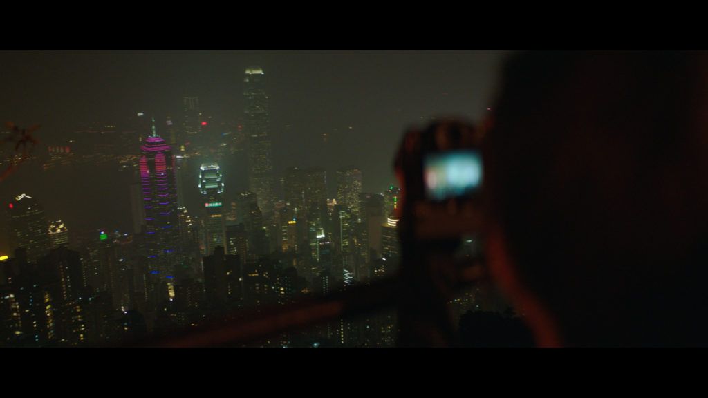 a person taking a picture of a city at night