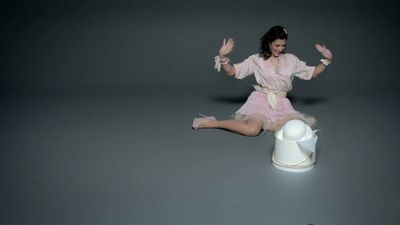 a woman sitting on the ground with her legs spread out