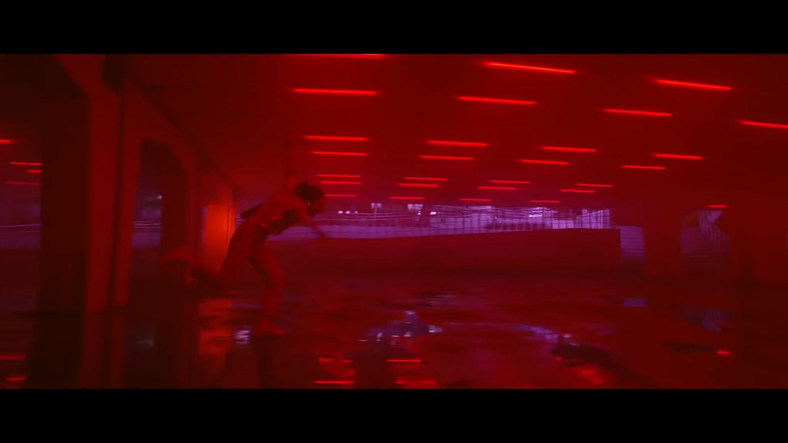 a man standing in a room with red lights