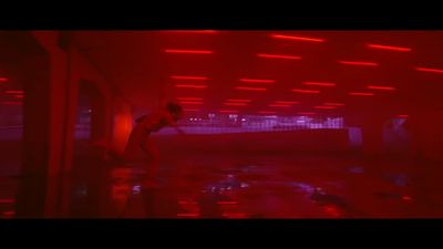 a man standing in a room with red lights