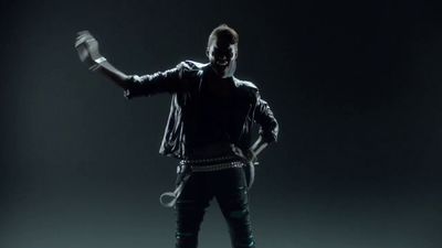 a man in a black leather jacket is dancing