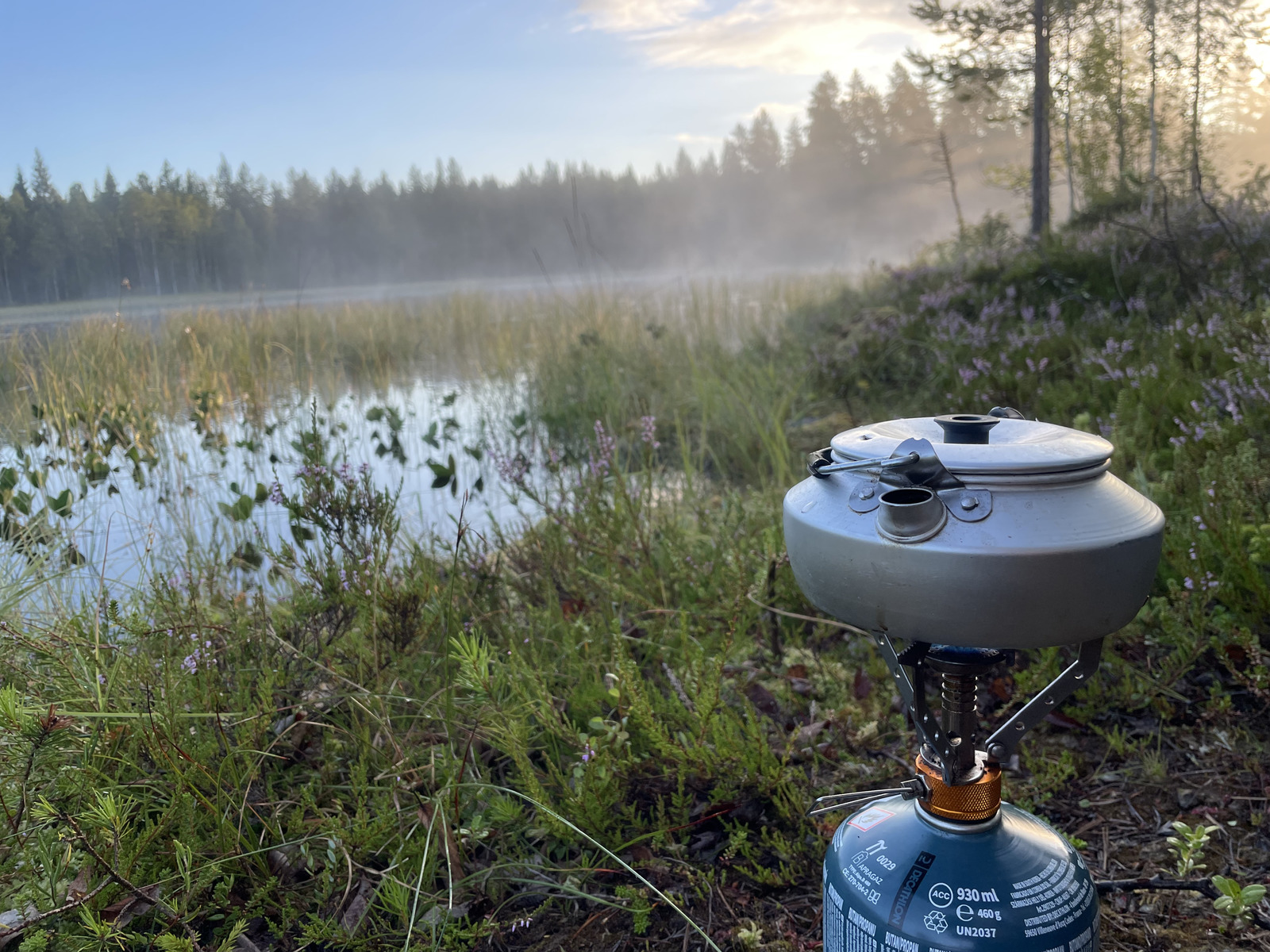 a blue propaner sitting on the side of a lake