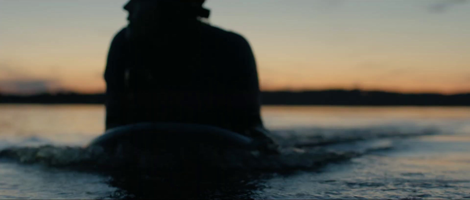 a person riding a surfboard on a body of water