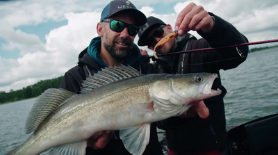 a man holding a fish on a boat