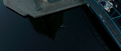 a man riding a surfboard on top of a body of water