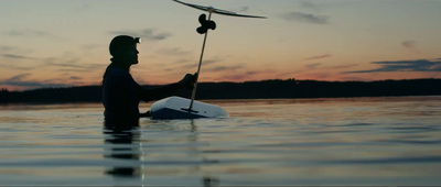 a man in a body of water holding a paddle