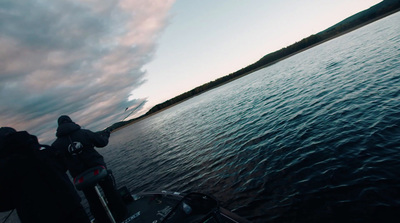 a man riding a boat on top of a body of water