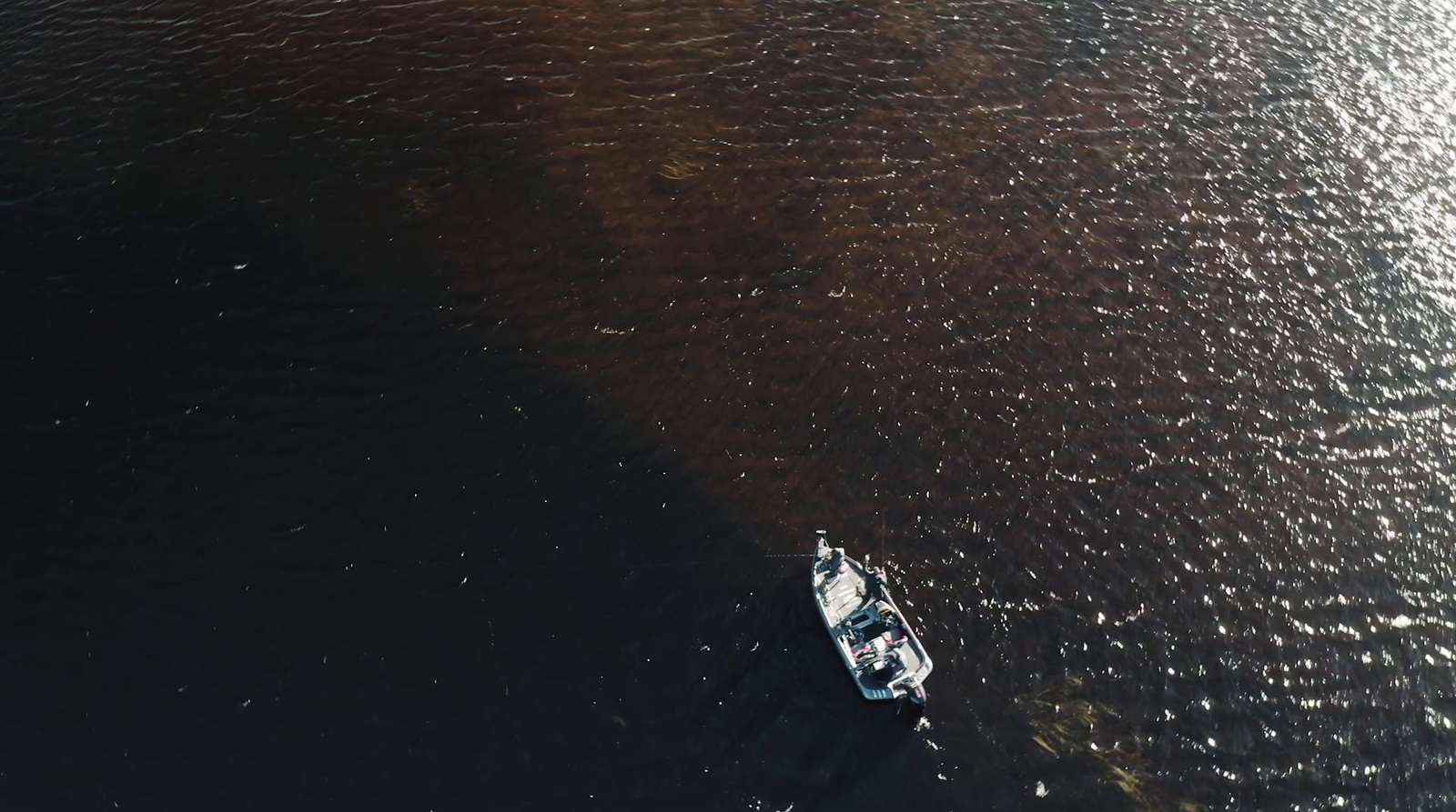 a small boat floating on top of a large body of water