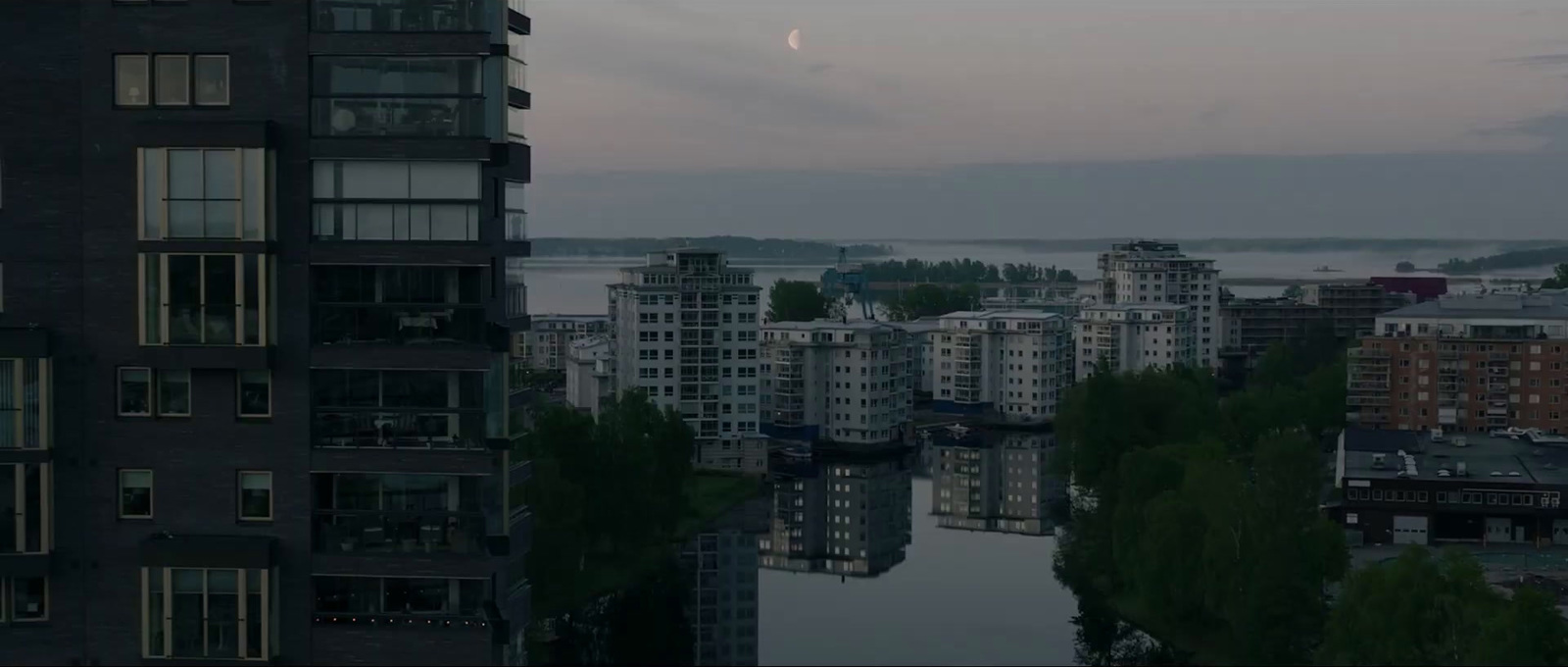 a full moon is seen over a city