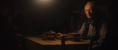 a man sitting at a table in a dark room