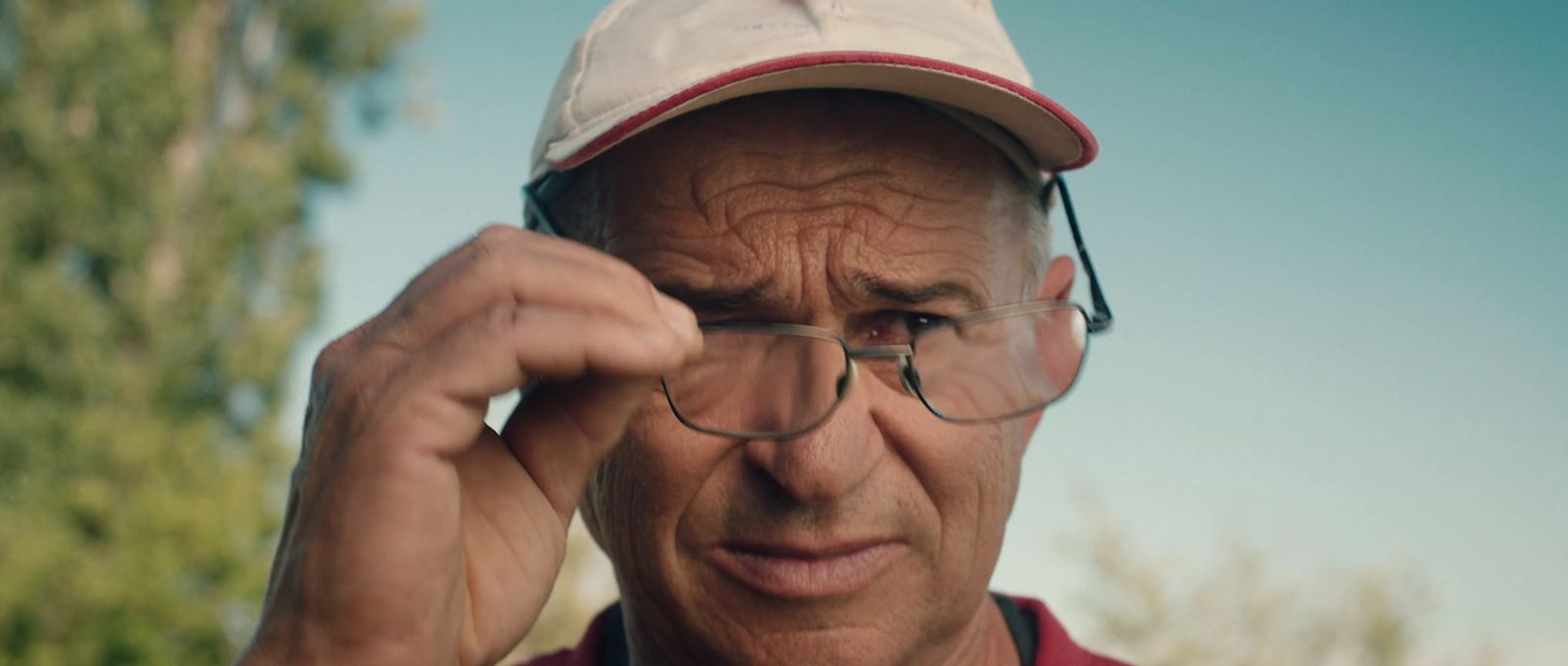 a man wearing glasses and a hat