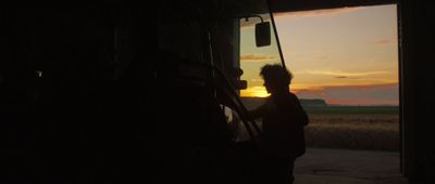 a person standing in front of a truck at sunset