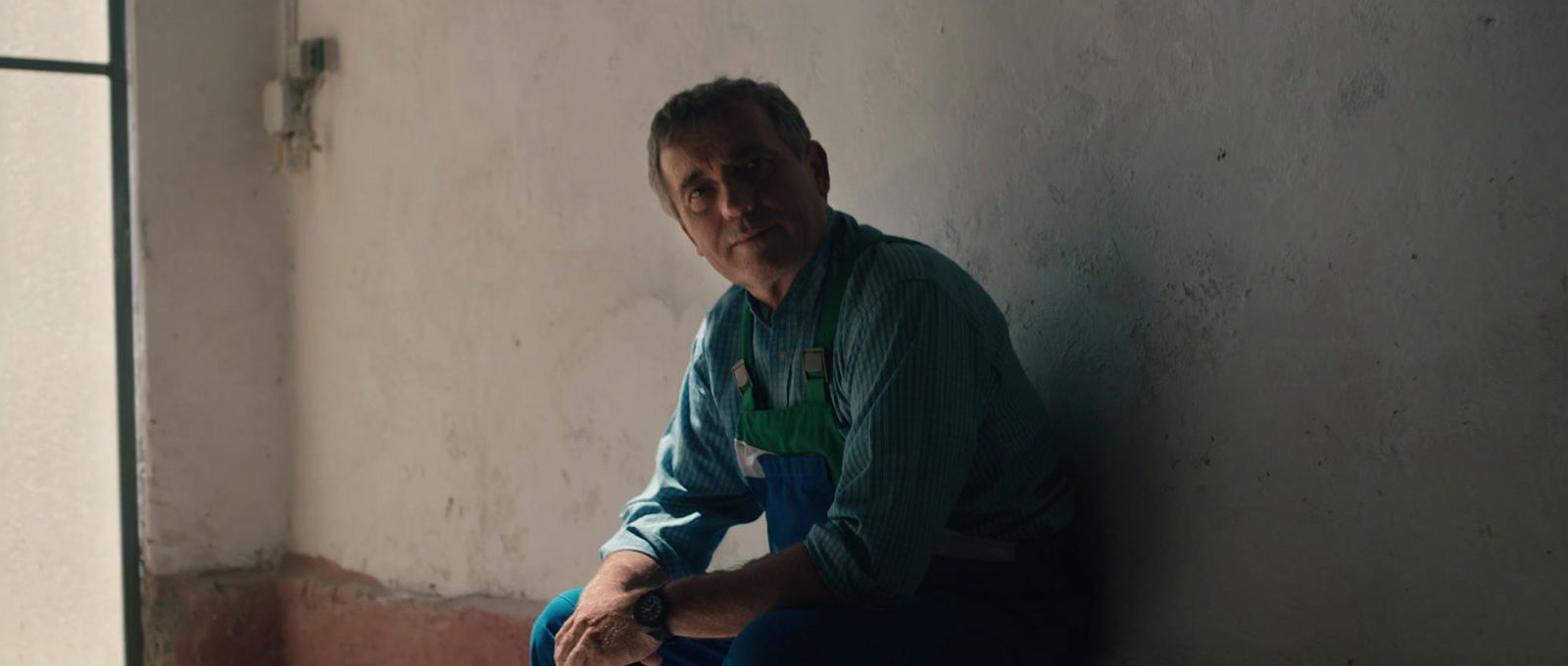 a man sitting on a window sill in a room