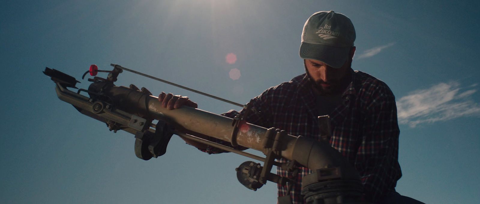 a man holding a large metal object in his hands