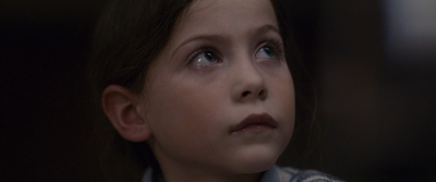 a close up of a child with a concerned look on her face