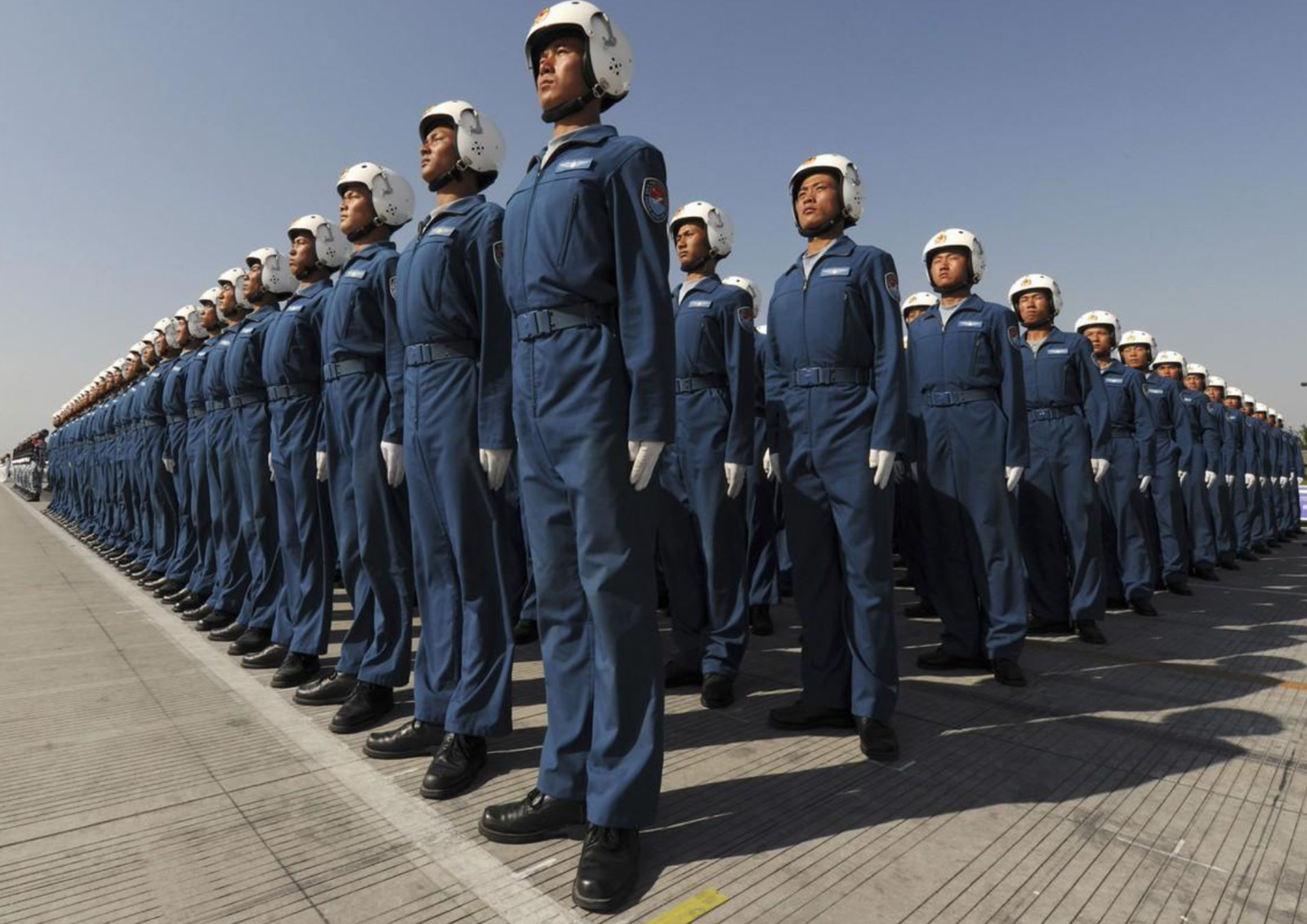 a group of men in blue uniforms standing next to each other