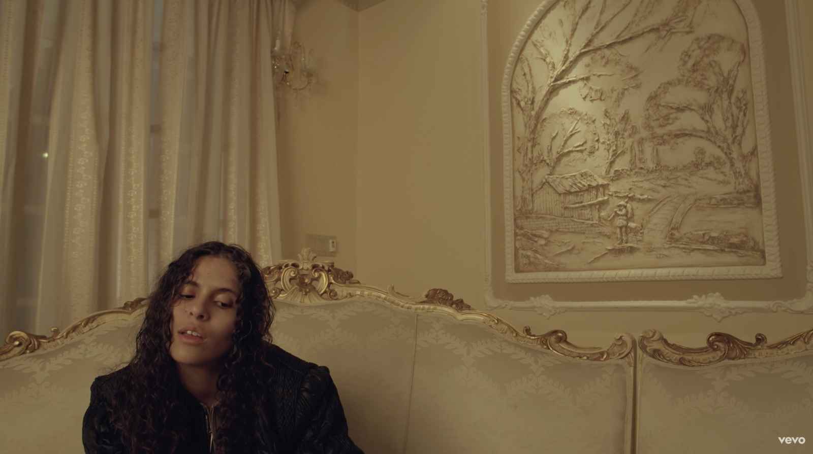 a woman sitting on top of a white couch