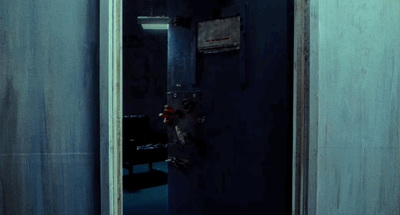 a dark room with a black door and a clock on the wall