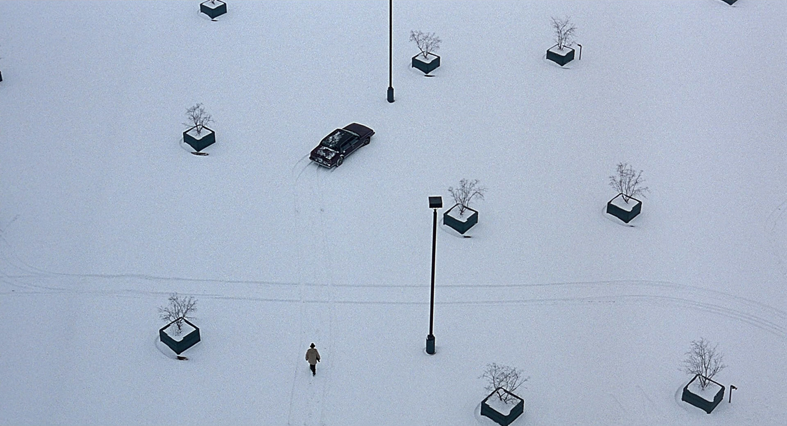 an aerial view of a snow covered parking lot